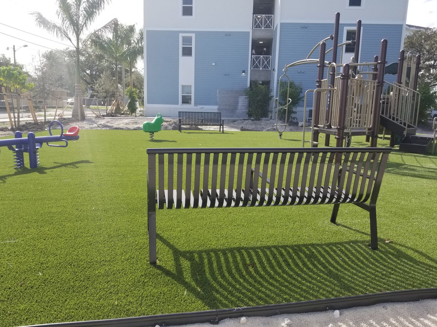 Playground with bench and artificial grass